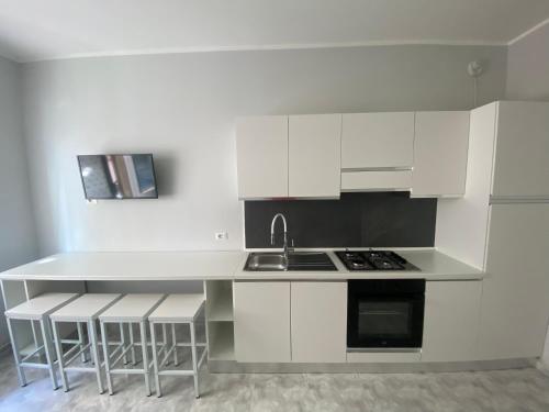 a kitchen with white cabinets and a sink and a counter at Annarè Home in Vasto