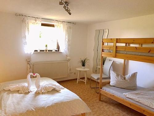 two swans sitting on a bed in a bedroom at Naturblick am Petersdorfer See in Petersdorf