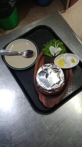 a tray with a plate of food on a table at Bag Packer's Lodge in Kathmandu
