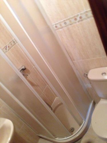 a bathroom with a toilet and a sink at Hostal Jose Luis in Brunete