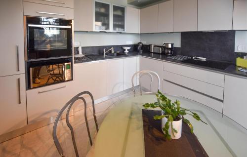 a kitchen with a table and chairs and a counter at Stunning Home In Morières-Lès-Avignon in Morières-lès-Avignon