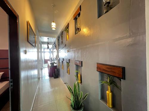 a hallway with a wall with paintings on it at Mount Ash Villa Hatton in Hatton