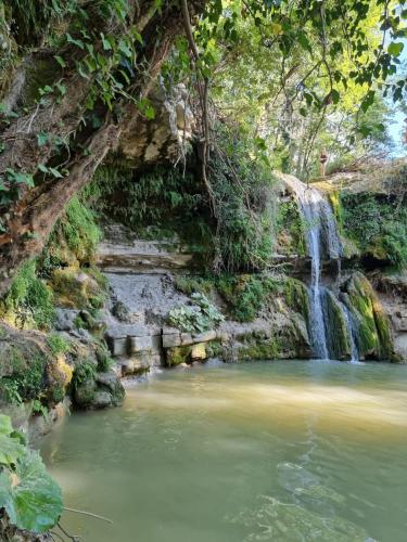 a waterfall in the middle of a pool of water at Agriturismo Casa del Vento in San Presto