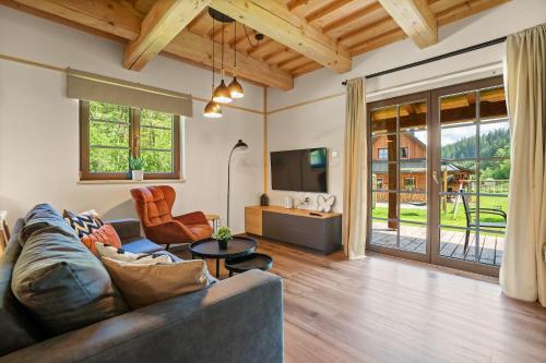 a living room with a couch and a tv at Dvě chalupy - Velké Karlovice in Velké Karlovice