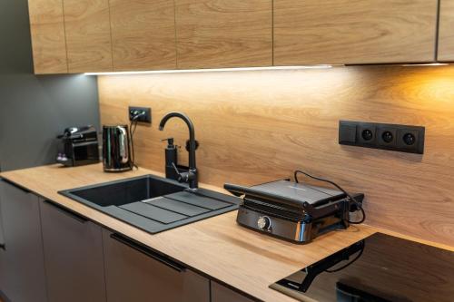 a kitchen with a sink and a toaster on a counter at Dvě chalupy - Velké Karlovice in Velké Karlovice