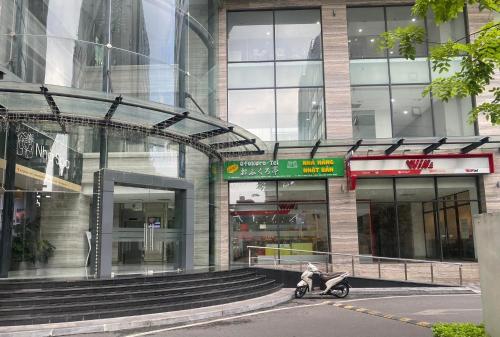 a scooter parked in front of a building at Hi-Home Suites - City view Apt in HongKong Tower in Hanoi