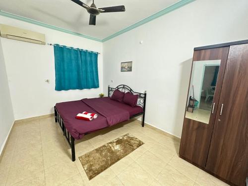 a bedroom with a bed and a ceiling fan at 4bhk Family Villa near beach-4K-6k per night in Colva