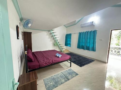 a bedroom with a red bed in a room at 4bhk Family Villa near beach-4K-6k per night in Colva