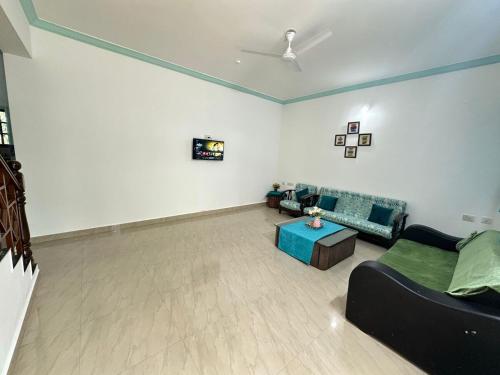 a living room with a couch and a table at 4bhk Family Villa near beach-4K-6k per night in Colva