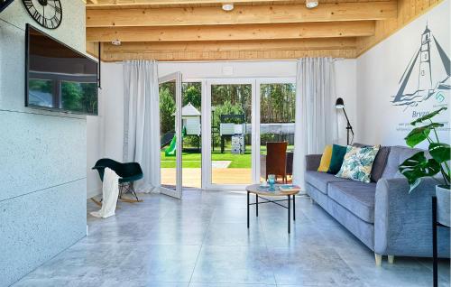 a living room with a couch and a table at Amazing Home In Bialogora With Wifi in Białogóra