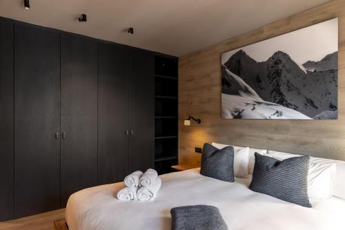 a bedroom with a bed with towels on it at Luxury Ski Chalet Andorra in Soldeu