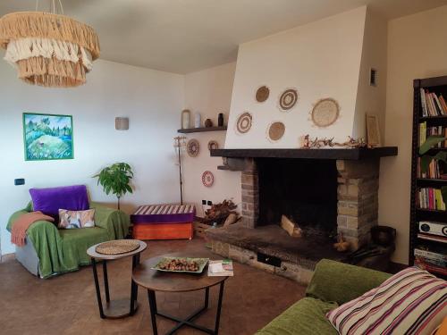 a living room with a couch and a fireplace at Agriturismo Casa del Vento in San Presto