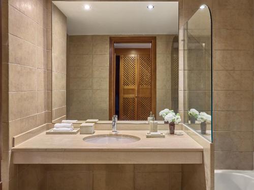 a bathroom with a sink and a mirror at Grecotel Egnatia in Alexandroupoli