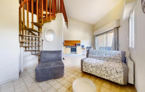 a living room with a couch and a staircase at Pet Friendly Apartment In Hyères in Hyères