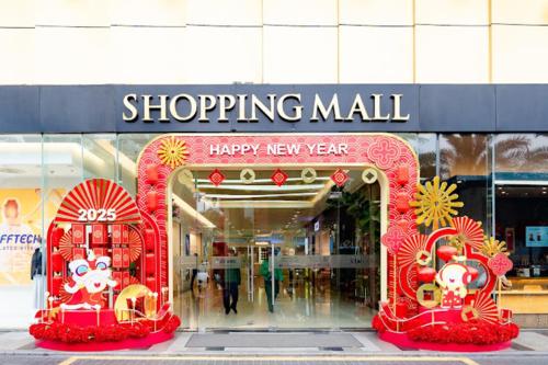 a store front of a shopping mall with a happy new year sign at Hi-Home Suites - Vinhomes Metropolis in Hanoi