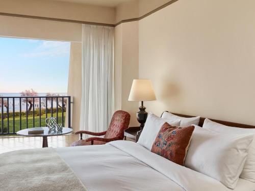 a bedroom with a bed and a balcony at Grecotel Egnatia in Alexandroupoli
