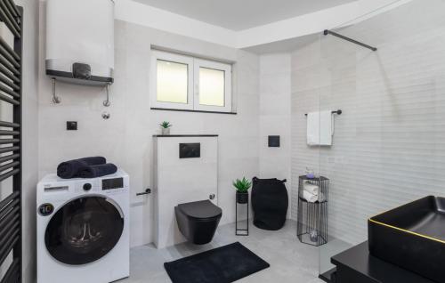 a bathroom with a washing machine and a toilet at Villa Filomena - Omis by Villas Guide in Blato na Cetini