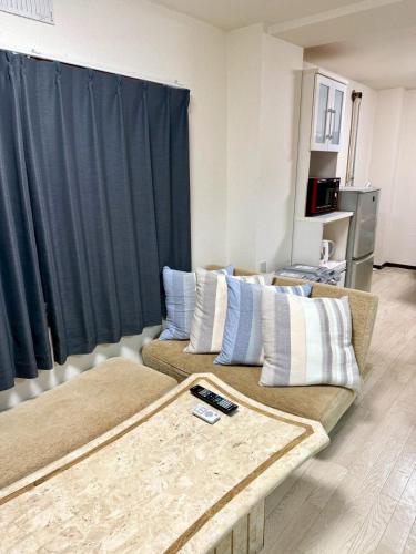 a living room with two couches in front of a window at KIYAZA River Sapporo in Sapporo