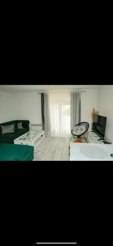 a room with two beds and a laptop on a table at Sunset Dream Home Konjic in Konjic