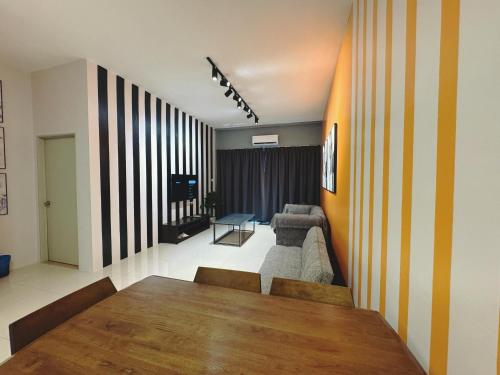 a living room with a table and a couch at Kuching Cozy Comfort 07 - Home Stay GEM Suites 7 Pax near Airport & Saradise in Kuching