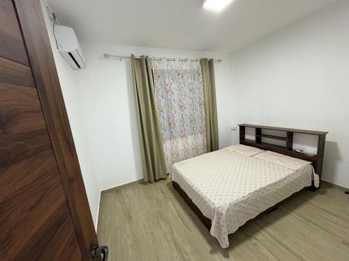 a small bedroom with a bed and a window at Residence Haulkory in Belle Vue