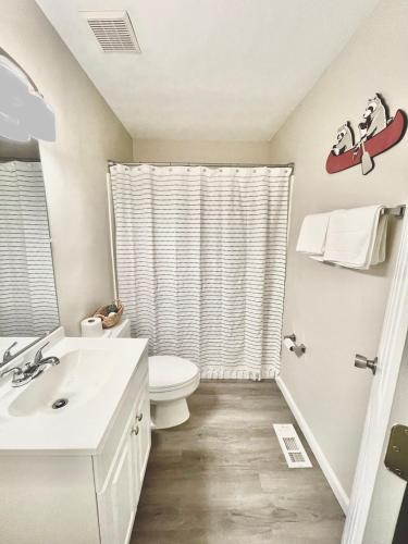 a bathroom with a toilet and a sink at Bungalow near the lake in Gainesville