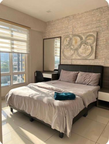 a bedroom with a large bed in a room at GA Homes Homestay - Majestic Ipoh Condo in Ipoh