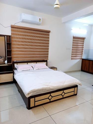 a bedroom with a bed with a wooden headboard at Nas Homestay in Cochin