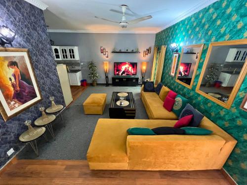 a living room with a couch and a fireplace at LUXURY family cottage in Islamabad