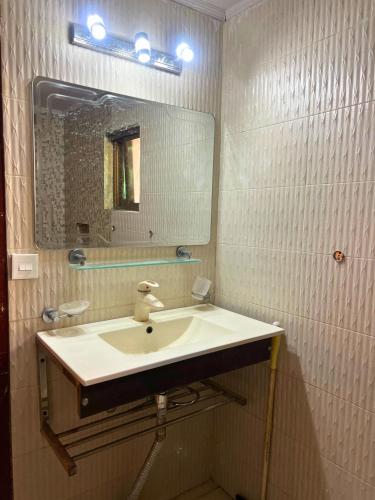 a bathroom with a sink and a mirror at LUXURY family cottage in Islamabad