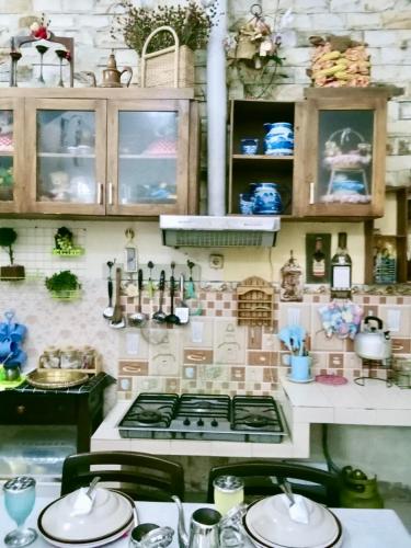 a kitchen with a stove and a counter top at Guest House Abimanyu in Kaliurang
