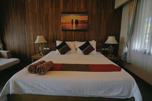 a bedroom with a large white bed with two lamps at Better View Koh Yao Yai in Ko Yao Yai