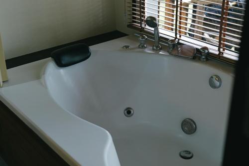 a white bath tub in a bathroom with a window at Better View Koh Yao Yai in Ko Yao Yai