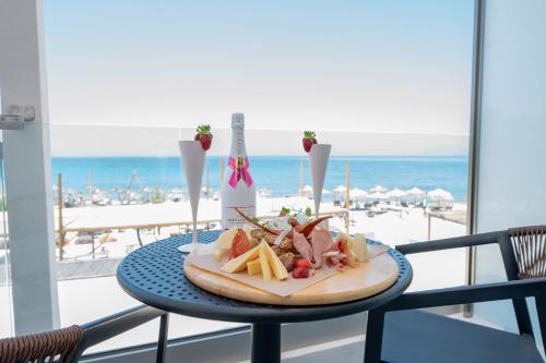 a plate of food on a table with a view of the beach at Panorama Seaside in Mastichari
