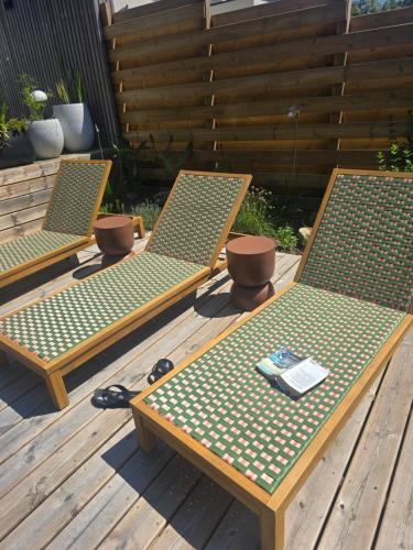 a pair of chairs sitting on a wooden deck at Villa Namasté SPA Hammam port & Mer in La Trinité-sur-Mer