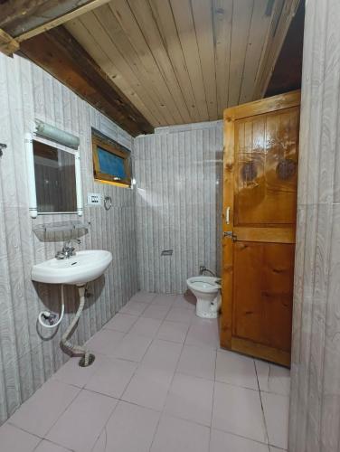 a bathroom with a sink and a toilet at Oran Stays Shoja in Shoja