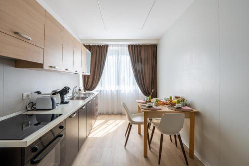 a kitchen with a table and chairs and a dining room at BnB Paoli in Rovereto