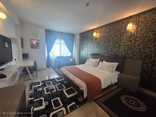 a hotel room with a bed and a television at Aster+ Hotel Bukit Jalil in Kuala Lumpur