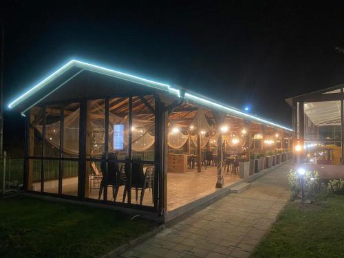 a building with lights on it at night at Aparthotel Hotel Prestige City II in Primorsko