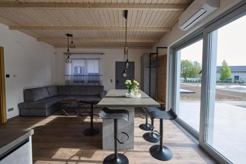 a kitchen and living room with a table and chairs at Klangor in Kopalino