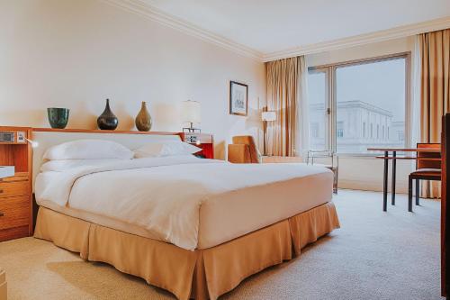 a large bedroom with a large bed and a desk at Grand Hyatt Istanbul in Istanbul