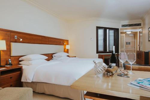 a bedroom with a large white bed and a table at Grand Hyatt Istanbul in Istanbul