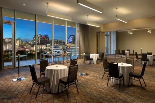 a restaurant with tables and chairs and a view of a city at Grand Hyatt San Antonio River Walk in San Antonio