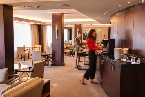 a woman standing in a kitchen in a hotel room at Grand Hyatt Istanbul in Istanbul