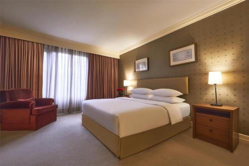 a hotel room with a bed and a chair at Grand Hyatt Istanbul in Istanbul