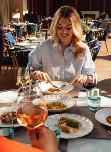 a woman sitting at a table with a plate of food at Grand Hyatt Istanbul in Istanbul