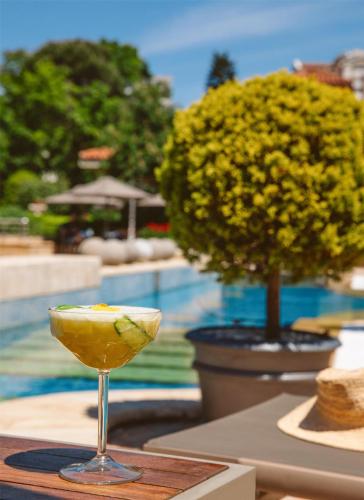 a drink sitting on a table next to a pool at Grand Hyatt Istanbul in Istanbul