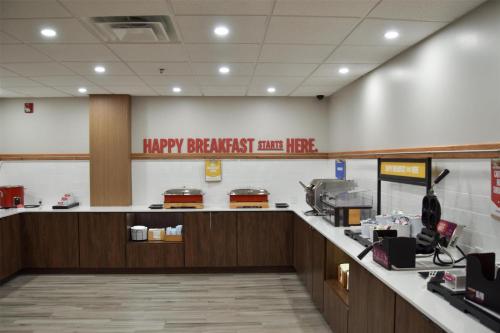 a restaurant with a happy breakfastarmaarma counter in aluajavascript at Hampton Inn Frankfort in Frankfort