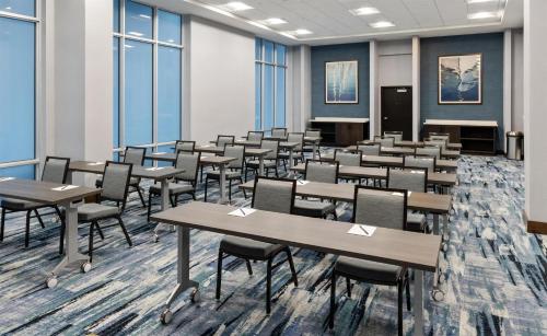 a classroom with desks and chairs in a room with windows at Hyatt Place West Palm Beach in West Palm Beach