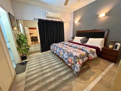 a bedroom with a large bed and a window at LUXURY family cottage in Islamabad